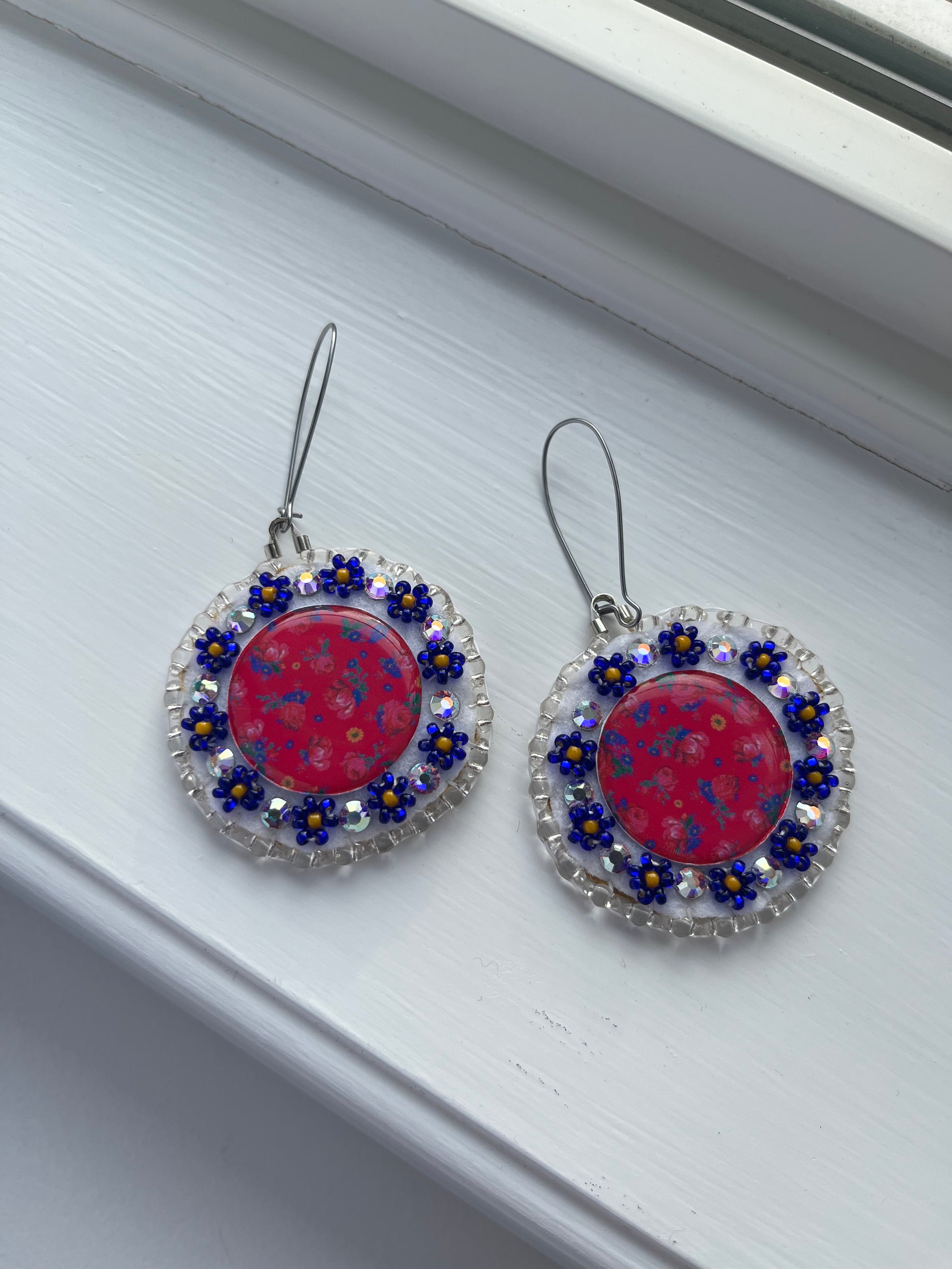 These full glam earrings will check that sparkle box for any diva. Hypoallergenic kidney hooks. Backed with soft deer skin and covered in Swarovski iridescent jewels. 